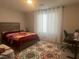 Comfortable bedroom featuring a cozy bed and a window with curtains at 7527 Ardenno St, North Las Vegas, NV 89084