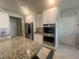 Modern kitchen with stainless steel appliances, granite counters, and ample storage space at 7527 Ardenno St, North Las Vegas, NV 89084