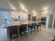 Spacious kitchen features a large island, stainless steel appliances, and sleek white cabinetry at 7527 Ardenno St, North Las Vegas, NV 89084