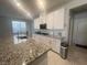 Stylish kitchen featuring granite countertops, stainless steel appliances, and a convenient layout at 7527 Ardenno St, North Las Vegas, NV 89084