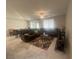 Comfortable living room with a large sectional sofa, ceiling fan, and tile flooring at 7527 Ardenno St, North Las Vegas, NV 89084