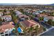 Stunning aerial view of a neighborhood showcasing beautiful homes, palm trees, and a blue pool at 7616 Gossamer Wind St, Las Vegas, NV 89139