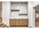 Stylish bar area with custom cabinets, marble countertop, and decorative tile backsplash at 7616 Gossamer Wind St, Las Vegas, NV 89139