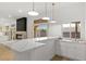Bright bar area features white countertops, sink, and windows with an outdoor view at 7616 Gossamer Wind St, Las Vegas, NV 89139