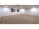 A large basement space with carpet floors and multiple windows at 7616 Gossamer Wind St, Las Vegas, NV 89139