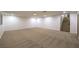 Expansive carpeted basement area with stairs leading to the upper level at 7616 Gossamer Wind St, Las Vegas, NV 89139