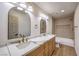 Updated bathroom featuring a double vanity with marble counters and gold fixtures at 7616 Gossamer Wind St, Las Vegas, NV 89139