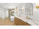 Bright bathroom featuring a soaking tub, wooden vanity, and designer lighting at 7616 Gossamer Wind St, Las Vegas, NV 89139