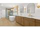 Luxurious bathroom featuring double vanities, an elegant soaking tub, and a separate glass shower at 7616 Gossamer Wind St, Las Vegas, NV 89139