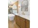 Bright bathroom featuring a soaking tub, wooden vanity, and designer lighting at 7616 Gossamer Wind St, Las Vegas, NV 89139