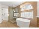 Bathroom featuring stand alone tub and tiled glass shower at 7616 Gossamer Wind St, Las Vegas, NV 89139