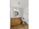 Updated bathroom with wood cabinets, marble countertop, and modern fixtures, offering a sleek and inviting atmosphere at 7616 Gossamer Wind St, Las Vegas, NV 89139