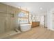 Bright bathroom features a soaking tub, glass enclosed shower and double sink vanity at 7616 Gossamer Wind St, Las Vegas, NV 89139