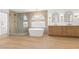 Spa-like bathroom with modern fixtures, soaking tub, and glass shower at 7616 Gossamer Wind St, Las Vegas, NV 89139