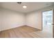 Bright bedroom features wood flooring and a doorway leading to additional rooms at 7616 Gossamer Wind St, Las Vegas, NV 89139