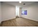 Bright bedroom with hard surface floors, a window, and stairs at 7616 Gossamer Wind St, Las Vegas, NV 89139