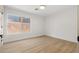 Bright bedroom featuring wood floors and a large window view at 7616 Gossamer Wind St, Las Vegas, NV 89139