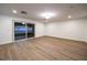 A brightly lit bedroom has wood flooring and sliding glass doors leading to the patio at 7616 Gossamer Wind St, Las Vegas, NV 89139