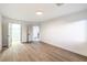 This bright bedroom features wood flooring and doorways leading to additional rooms at 7616 Gossamer Wind St, Las Vegas, NV 89139