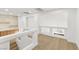 Bright bonus room featuring hardwood floors, white walls and staircase access at 7616 Gossamer Wind St, Las Vegas, NV 89139