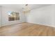 Minimalist dining room with hardwood floors, modern light fixture and natural light from large window at 7616 Gossamer Wind St, Las Vegas, NV 89139