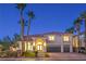Charming front exterior featuring mature palm trees and well manicured landscaping at 7616 Gossamer Wind St, Las Vegas, NV 89139