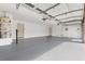 Spacious three car garage featuring epoxy floors, utility sink, and plenty of room for storage at 7616 Gossamer Wind St, Las Vegas, NV 89139