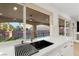 Kitchen sink area with a view of the pool and backyard, featuring modern fixtures at 7616 Gossamer Wind St, Las Vegas, NV 89139