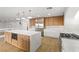 Modern kitchen featuring custom cabinets, a center island, and stainless steel appliances at 7616 Gossamer Wind St, Las Vegas, NV 89139