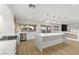 Contemporary kitchen featuring stainless steel appliances, light wood floors, and access to the backyard at 7616 Gossamer Wind St, Las Vegas, NV 89139