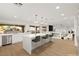 Bright kitchen with a long island, stainless appliances and open concept to other living spaces at 7616 Gossamer Wind St, Las Vegas, NV 89139