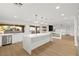 Modern kitchen with stainless appliances, white cabinets, and hardwood floors at 7616 Gossamer Wind St, Las Vegas, NV 89139