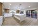 Bright, open kitchen with custom cabinets, a center island, and sliding glass doors to the backyard at 7616 Gossamer Wind St, Las Vegas, NV 89139