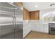 Kitchen with white cabinets, stainless steel refrigerator, and modern appliances at 7616 Gossamer Wind St, Las Vegas, NV 89139