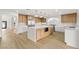 Bright kitchen featuring a large island, wood cabinets, stainless steel appliances, and hardwood floors at 7616 Gossamer Wind St, Las Vegas, NV 89139