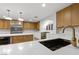 Modern kitchen featuring stainless steel appliances, a large island, and wood cabinetry at 7616 Gossamer Wind St, Las Vegas, NV 89139