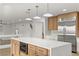 Open-concept kitchen with a center island, stainless steel appliances, and a light-filled atmosphere at 7616 Gossamer Wind St, Las Vegas, NV 89139