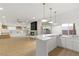 Stylish kitchen featuring a bar, granite countertops, and an open layout to the living area at 7616 Gossamer Wind St, Las Vegas, NV 89139