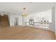 Open concept living area showcasing hardwood floors and modern chandeliers at 7616 Gossamer Wind St, Las Vegas, NV 89139