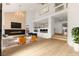 Open-concept living room features a modern fireplace, high ceilings, and bright, natural light at 7616 Gossamer Wind St, Las Vegas, NV 89139
