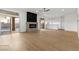 Spacious living room with wood floors, modern fireplace, wet bar, and access to the backyard, ideal for Gathering gatherings at 7616 Gossamer Wind St, Las Vegas, NV 89139