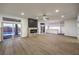 Open concept living room with a fireplace, modern lighting and easy access to the backyard at 7616 Gossamer Wind St, Las Vegas, NV 89139