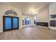 Spacious living room with soaring ceilings, modern lighting, and a sleek fireplace at 7616 Gossamer Wind St, Las Vegas, NV 89139