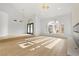 Open living room with natural light, light wood floors, and modern chandeliers at 7616 Gossamer Wind St, Las Vegas, NV 89139