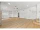 Bright living room features wood floors and a modern ceiling fan at 7616 Gossamer Wind St, Las Vegas, NV 89139