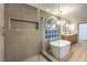 Luxurious bathroom featuring a frameless shower and modern tub at 7616 Gossamer Wind St, Las Vegas, NV 89139