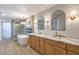 Elegant main bathroom with a freestanding tub, double vanity, and modern fixtures at 7616 Gossamer Wind St, Las Vegas, NV 89139