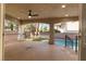 Covered patio provides shade and views of the pool, surrounded by a secure fence and landscaping at 7616 Gossamer Wind St, Las Vegas, NV 89139