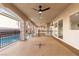 Spacious covered patio with ceiling fans and columns overlooking the pool, offering ample space for outdoor relaxation at 7616 Gossamer Wind St, Las Vegas, NV 89139