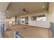 Large covered patio with ceiling fan, stone flooring, and views of the surrounding neighborhood at 7616 Gossamer Wind St, Las Vegas, NV 89139